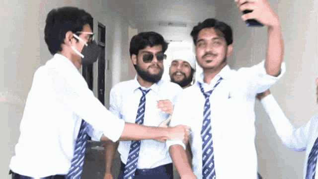 a group of young men wearing white shirts and blue ties