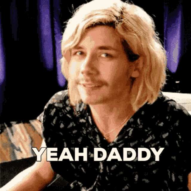 a man with long blonde hair says yeah daddy