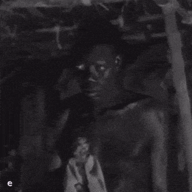 a black and white photo of a shirtless man with the word lunes in yellow