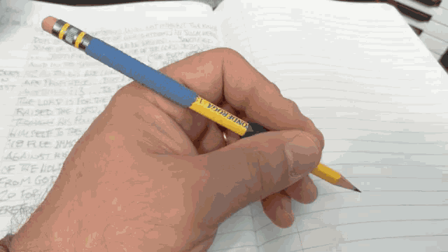 a person is writing in a notebook with a pencil that says " one more " on it