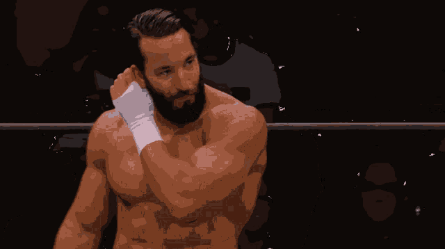 a man with a beard is sitting in front of a aew wrestling chair