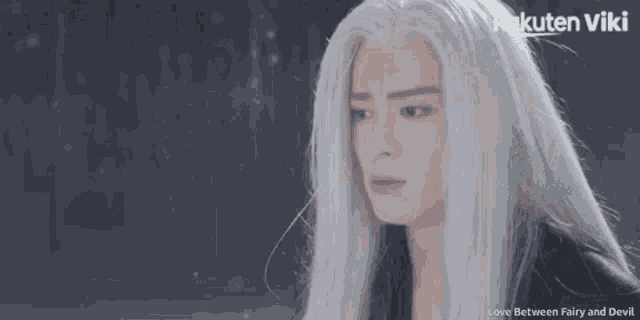 a woman with long white hair is crying with rakuten viki written on the bottom