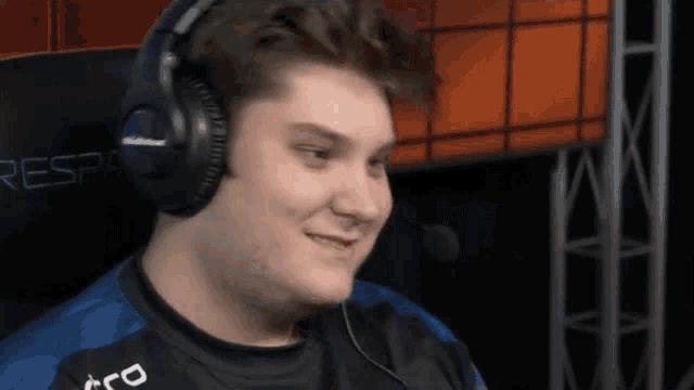 a man wearing headphones is smiling in front of a sign that says resp