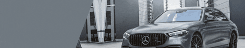 a mercedes benz is parked in front of a building