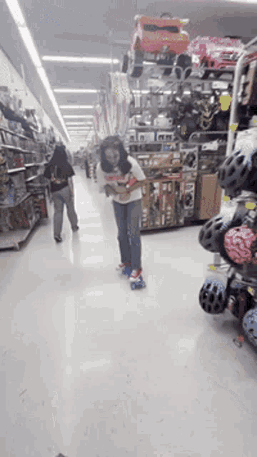 a little girl rollerblading in a store aisle while a woman looks on