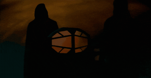 a silhouette of a person with a lantern in the foreground
