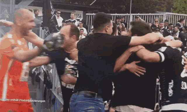 a group of people hugging each other in front of a sign that says issa