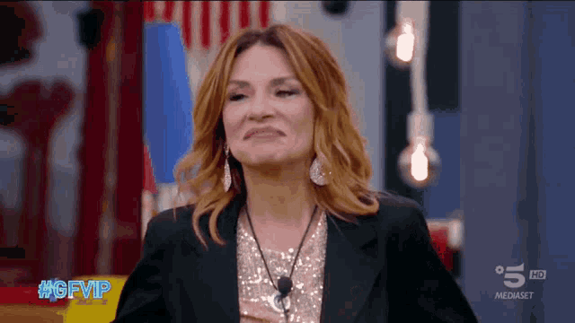 a woman is making a funny face on a tv show called gfvip