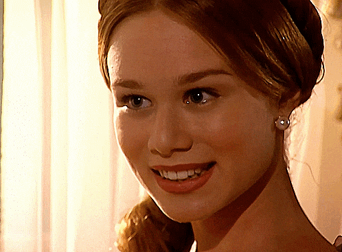 a close up of a woman 's face with her mouth open