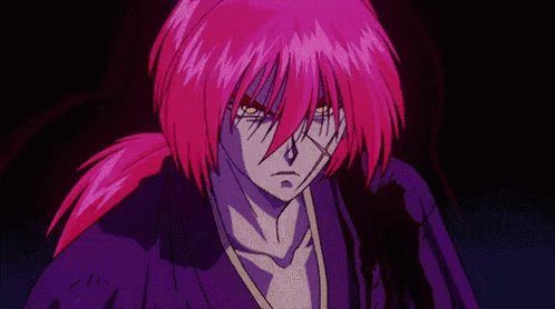 a man with purple hair and yellow eyes is standing in the dark .