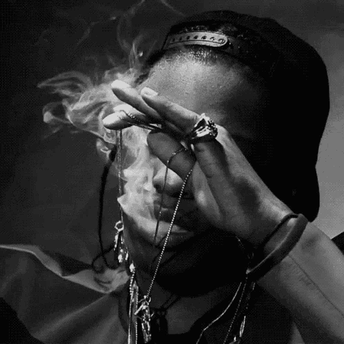 a black and white photo of a man covering his face with his hands