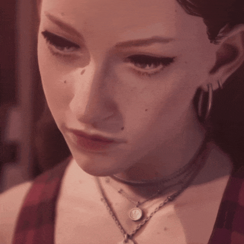 a close up of a woman 's face wearing a choker and earrings
