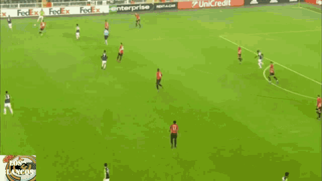 a soccer field with fedex and unicredit signs