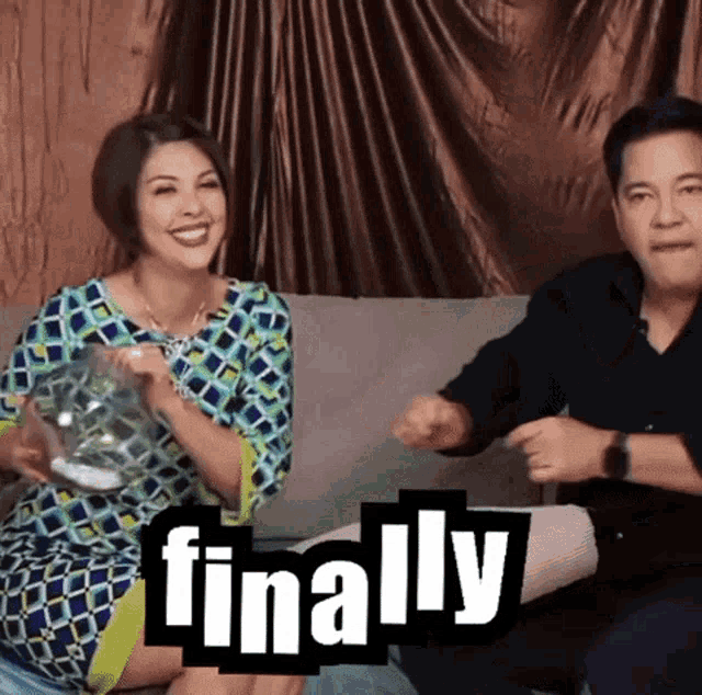 a man and a woman are sitting on a couch with the word finally written on the bottom