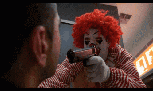 a clown is holding a gun in front of a sign that says lite