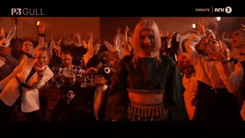 a group of people are dancing in front of a screen that says direkte