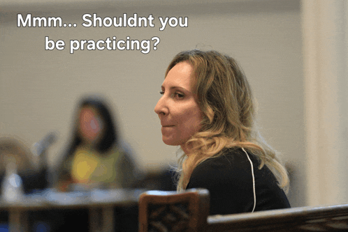 a woman sitting in a chair with the words shouldnt you be practicing written above her