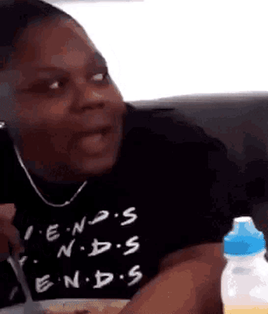 a man wearing a black shirt that says " friends " on it
