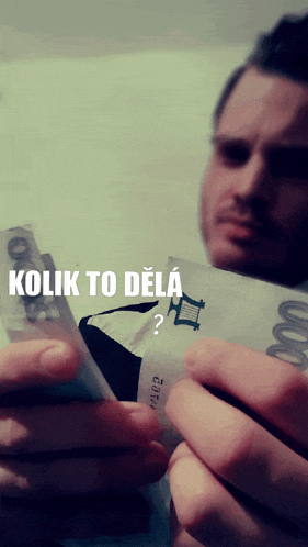 a man is holding a stack of money with the words kolik to dela written on it
