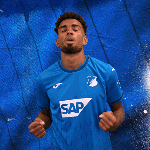 a man is wearing a blue shirt with the word sap on it