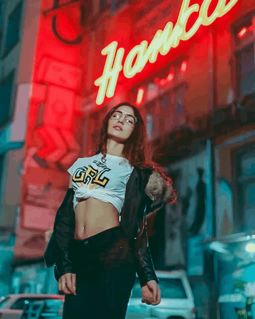 a woman wearing a crop top that says grl