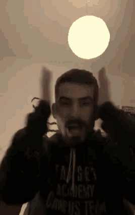 a man with a beard is wearing a campus team hoodie