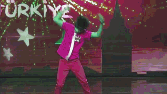 a man is dancing in front of a sign that says ' turkey '