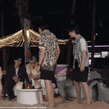 a group of people are gathered on a beach with a sign that says summer 2023 on the bottom