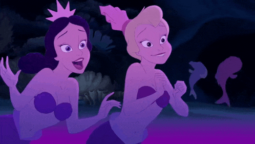 two mermaids are standing next to each other in a dark cave