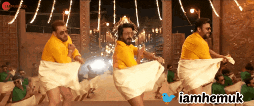 a group of men are dancing in front of a twitter logo