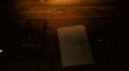 a piece of paper is laying on a table next to a lighter