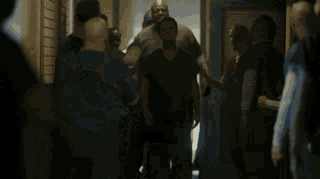 a man wearing glasses is standing next to another man who is screaming