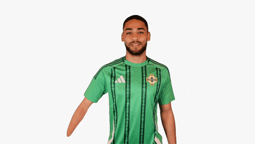 a man wearing a green shirt with the word adidas on the front