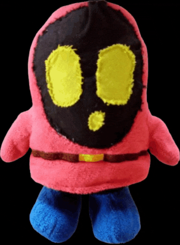 a pink stuffed animal with yellow eyes and a black mask