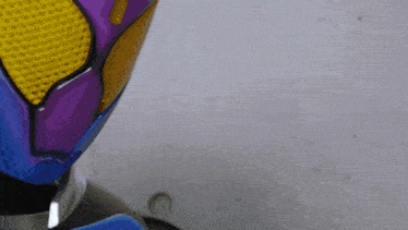 a close up of a purple and yellow helmet