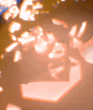a blurred image of a person 's face with a red glowing object in the foreground