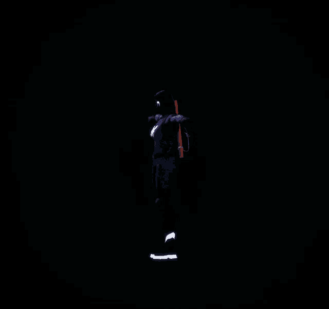 a person is standing in the dark with their arms outstretched ..