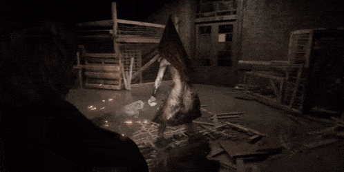 a person is standing in a dark room wearing a pyramid hat .