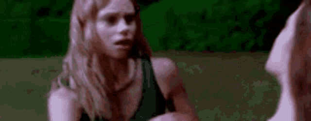 a woman is kissing another woman on the neck in a movie .