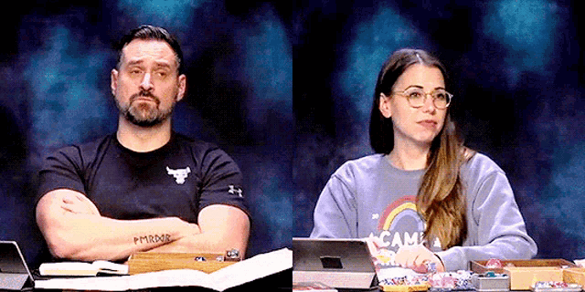 a man and a woman are sitting at a table with a blue background .