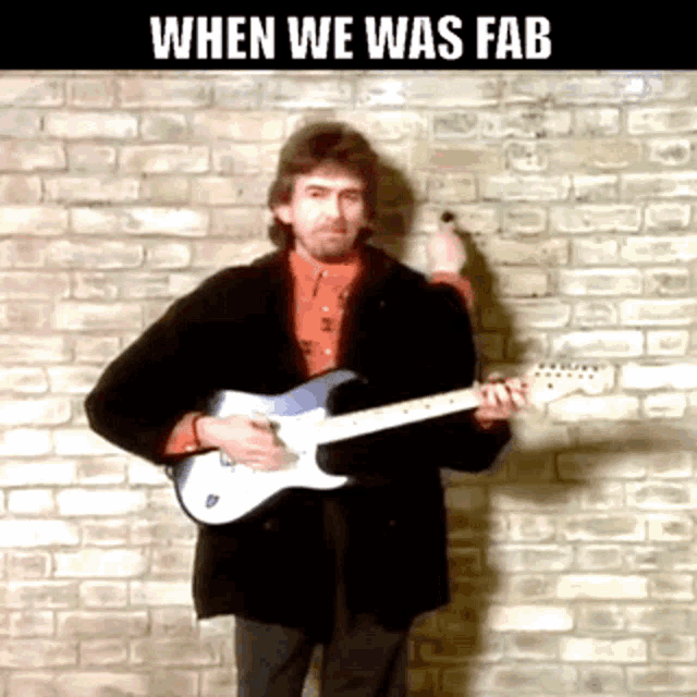 a man playing a guitar in front of a brick wall with the words " when we was fab " on the bottom