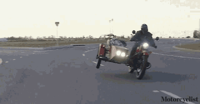 a man riding a motorcycle with a sidecar that says motorcyclelist on the bottom
