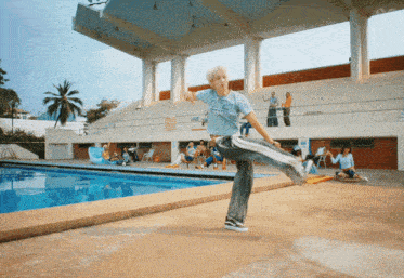 a person standing in front of a swimming pool with a sign that says ' a ' on it