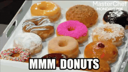 a variety of donuts on a tray with the words mmmm donuts below them