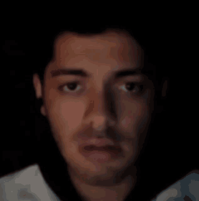 a close up of a man 's face with a serious look on his face
