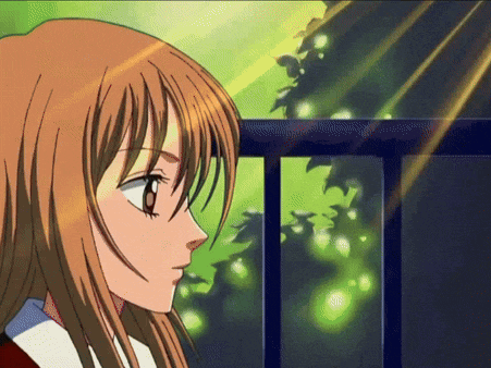 a girl with long brown hair is looking out over a fence