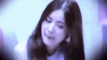 a close up of a woman 's face with a purple background .