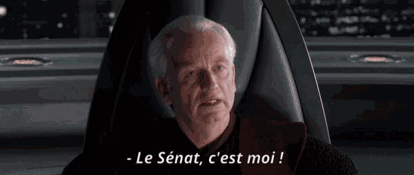 a man sitting in a chair with the words " le senat c'est moi " on the bottom