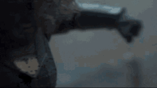 a close up of a person 's arm and leg in a dark room .