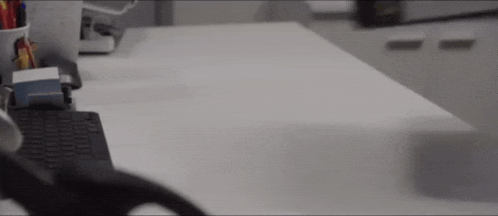 a person is sitting at a desk with a keyboard and mouse on it .